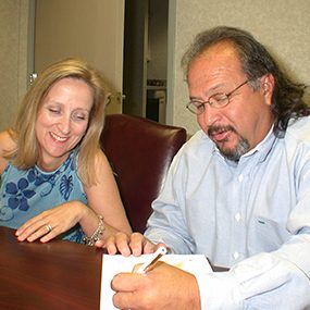 Signing the Listing Agreement Happy couple signing papers